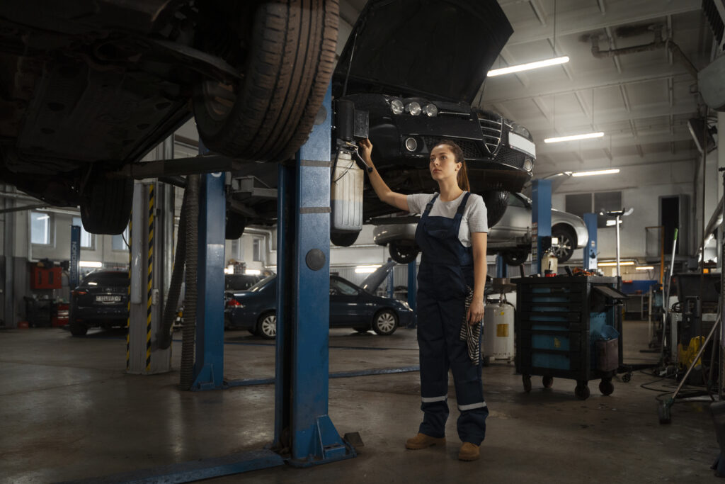 female-mechanic-working-shop-car